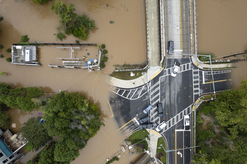 Peachtree Creek spills over its banks at Northside Drive NW in Atlanta on Friday, Sept. 27, 2024 following a night of heavy rain from Hurricane Helene. Ben Gray for the Atlanta Journal-Constitution