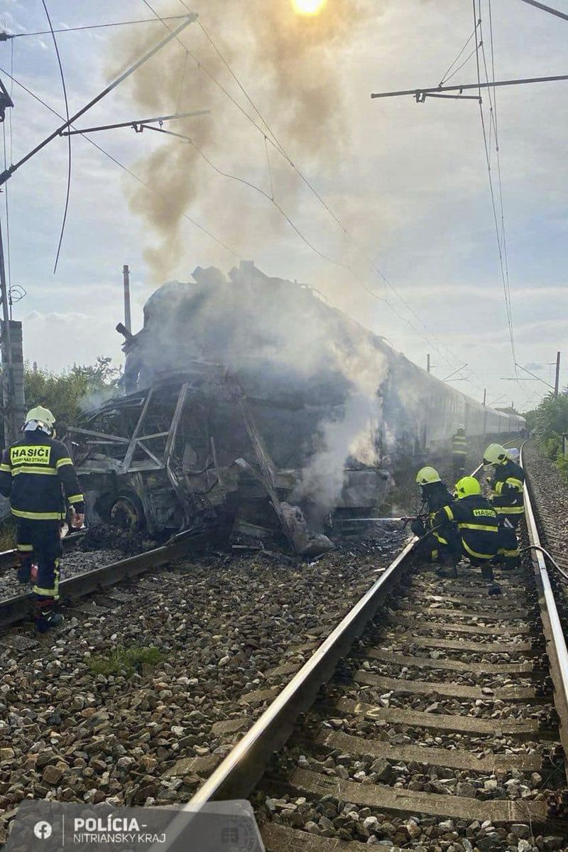 Firefighters work at the scene of a collision between a EuroCity train and a bus near Nove Zamky, southern Slovakia, Thursday, June 27, 2024. Some 200 people were aboard the train traveling from the Czech capital of Prague crossing through Slovakia on its way to the Hungarian capital of Budapest when the accident took place shortly Thursday after 5 p.m. (1500 GMT) at a crossing near the town of Nove Zamky. The collision that left seven people dead was likely caused by human error, the Slovak transport minister said on Friday, June 28, 2024. (AP Photo/Slovak Police via AP)