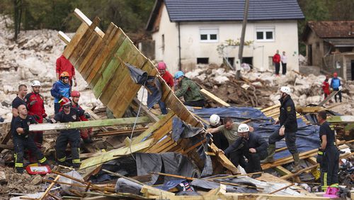 Rescuers search for missing people after floods and landslides in the village of Donja Jablanica, Bosnia, Saturday, Oct. 5, 2024. (AP Photo/Armin Durgut)