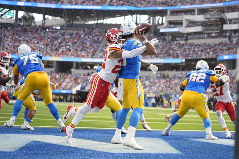 Los Angeles Chargers quarterback Justin Herbert throws under pressure from Kansas City Chiefs cornerback Trent McDuffie (22) during the first half of an NFL football game Sunday, Sept. 29, 2024, in Inglewood, Calif. (AP Photo/Ashley Landis)