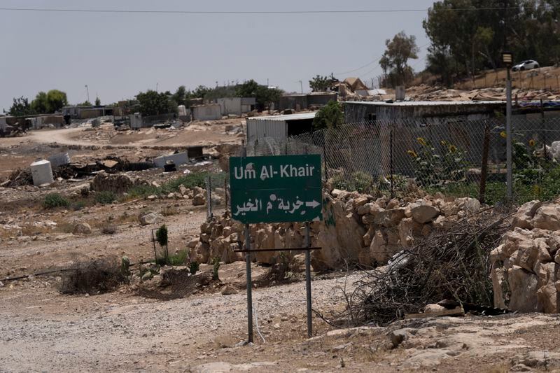 FILE - Caravans and simple structures for residents of the West Bank Bedouin village of Umm al-Khair, are seen at the entrance on July 10, 2024. (AP Photo/Maya Alleruzzo, File)