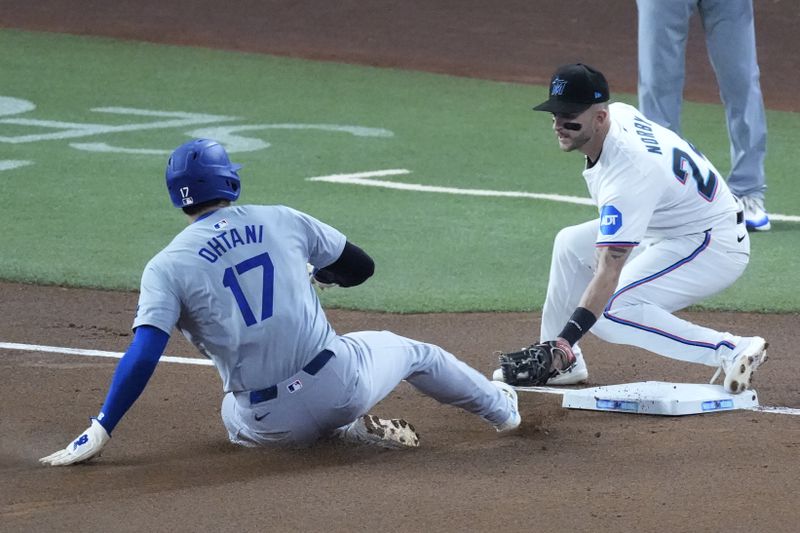 Los Angeles Dodgers' Shohei Ohtani (17) of Japan, steals third base as Miami Marlins third baseman Connor Norby attempts the tag during the first inning of a baseball game, Thursday, Sept. 19, 2024, in Miami. (AP Photo/Wilfredo Lee)