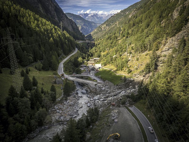 A road is blocked in Eisten, Switzerland, Friday, Sept. 5, 2024, after a landslide following severe weather. (Andrea Soltermann/Keystone via AP)