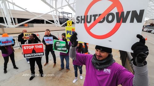 Air traffic controller Rafael Naveira and fellow ATC workers protest the federal shutdown at the north terminal.