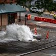 Water spewed out of a broken water main at 11th and West Peachtree streets in Midtown Atlanta on Sunday, June 2, 2024 (Ben Hendren for the Atlanta Journal-Constitution)