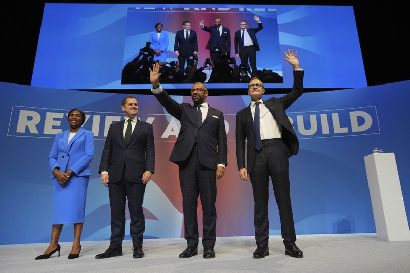 Conservative leadership candidates Kemi Badenoch, from left, Robert Jenrick, James Cleverly and Tom Tugendhat stand on the podium during the Conservative Party Conference at the International Convention Centre in Birmingham, England, Wednesday, Oct. 2, 2024.(AP Photo/Kin Cheung)