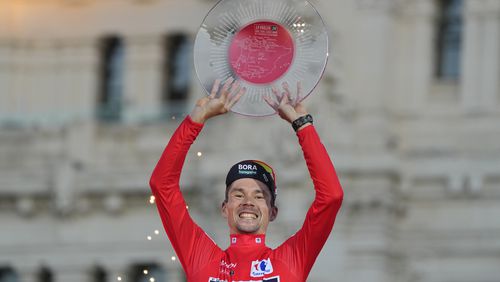 Primoz Roglic of Slovenia lifts the trophy after winning La Vuelta cycling race during the last stage in Madrid, Spain, Sunday, Sept. 8, 2024. (AP Photo/Paul White)