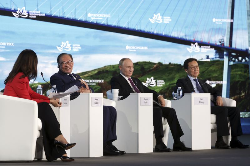 From left: TV presenter "Russia 24" Alexandra Suvorova, Malaysia's Prime Minister Anwar Ibrahim, Russian President Vladimir Putin, and China's Vice President Han Zheng attend the plenary session of the Eastern Economic Forum in Vladivostok, Russia, Thursday, Sept. 5, 2024. (Vyacheslav Prokofyev, Sputnik, Kremlin Pool Photo via AP)