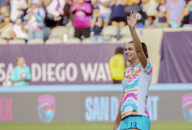 San Diego Wave's Alex Morgan waves before the start of an NWSL soccer game against the North Carolina Courage on Sunday, Sept. 8 2024, in San Diego. (Sandy Huffaker/The San Diego Union-Tribune via AP)