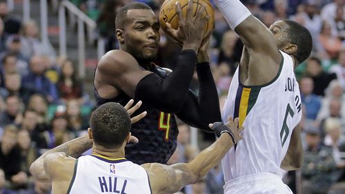 Utah Jazz’s Joe Johnson (6) and George Hill (3) defend against Atlanta Hawks forward Paul Millsap (4) in the first half during an NBA basketball game Friday, Nov. 25, 2016, in Salt Lake City. (AP Photo/Rick Bowmer)