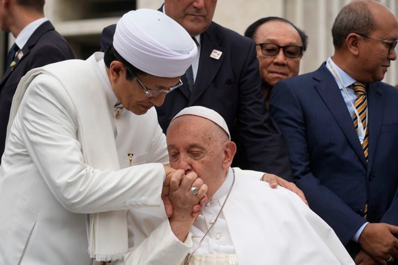 Pope Francis, bids farewell to The Grand Imam Nasaruddin Umar, left, as he leaves after signing the "Joint Declaration of Istiqlal 2024" at the Istiqlal Mosque in Jakarta, Thursday, Sept. 5, 2024. Even in the most delicate moment of his Asian trip in Jakarta, at Southeast Asia's biggest mosque, Francis threw protocol aside and kissed the hand of the grand imam and brought it to his cheek in gratitude. (AP Photo/Gregorio Borgia)