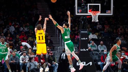 Atlanta Hawks guard Trae Young (11)shoots over Boston Celtics forward Jayson Tatum (0) during the first half of an NBA basketball game Friday, Jan. 28, 2022, in Atlanta. (AP Photo/Hakim Wright Sr.)