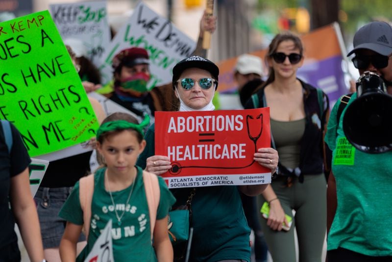 Abortion rights activists protest in Atlanta on July 21, 2022, the day after  a federal appeals court allowed Georgia’s restrictive “heartbeat” abortion law to take effect. Planned Parent Votes is taking aim at the law in a new ad this week. (Arvin Temkar/AJC)