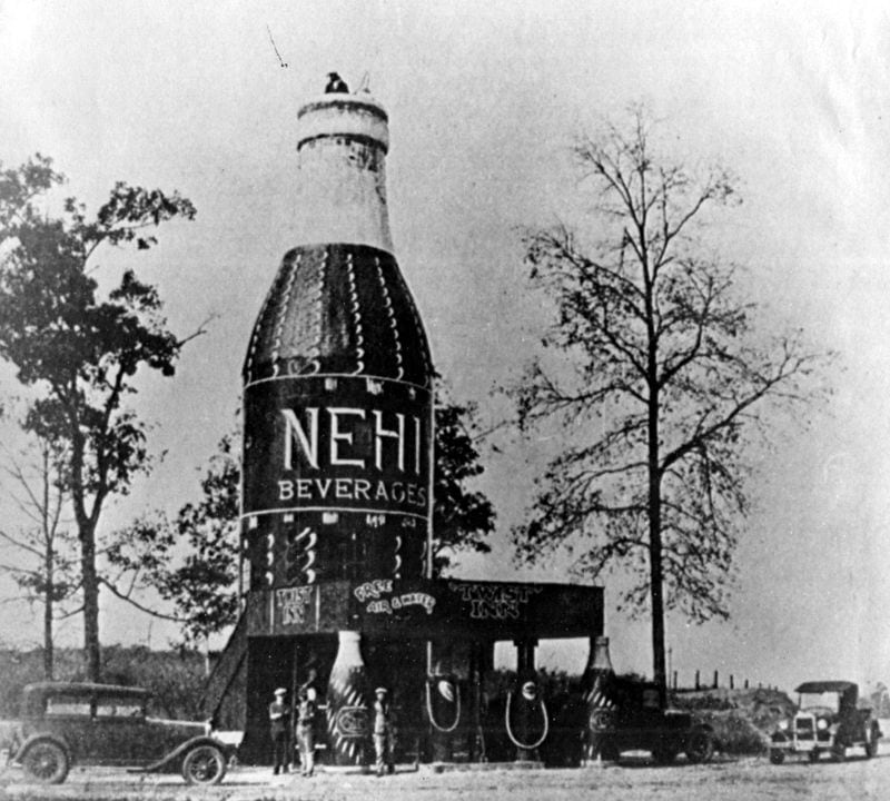 A giant Nehi bottle was located in Alabama during the 1920s and ’30s. It was a popular tourist attraction (note the tourist atop the cap). (Associated Press)