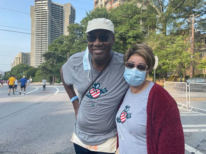 Wendy and George Harris, who live in Atlanta’s West End, have volunteered at the race for more than 15 years. (Photo: Anjali Huynh/AJC)