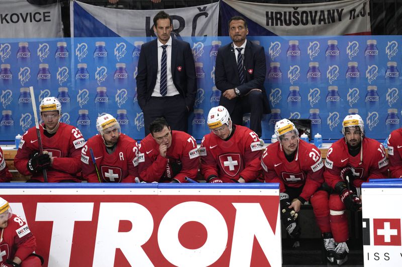 Members of the Switzerland team sit at their bench after they were defeated by Czech Republic 2-0 in a gold medal match at the Ice Hockey World Championships in Prague, Czech Republic, Sunday, May 26, 2024. (AP Photo/Darko Vojinovic)
