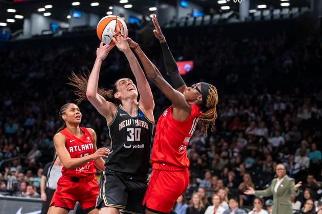 New York Liberty forward Breanna Stewart (30) is defended by Atlanta Dream guard Rhyne Howard (10) during the first half of a WNBA basketball first-round playoff game Sunday, Sept. 22, 2024, in New York. (AP Photo/Corey Sipkin)