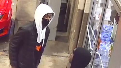 Atlanta police are looking to identify two men accused of ambushing a woman outside a southwest Atlanta gas station last week and robbing her at gunpoint.