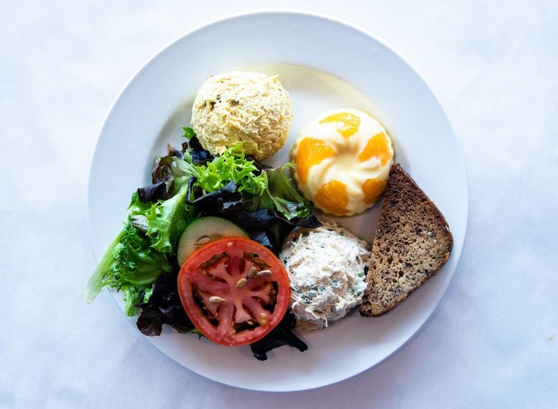 The Mandarin Orange Souffle plate at Cafe Lapin comes with a scoop (or two) of chicken salad and a slice of banana bread. CONTRIBUTED BY HENRI HOLLIS