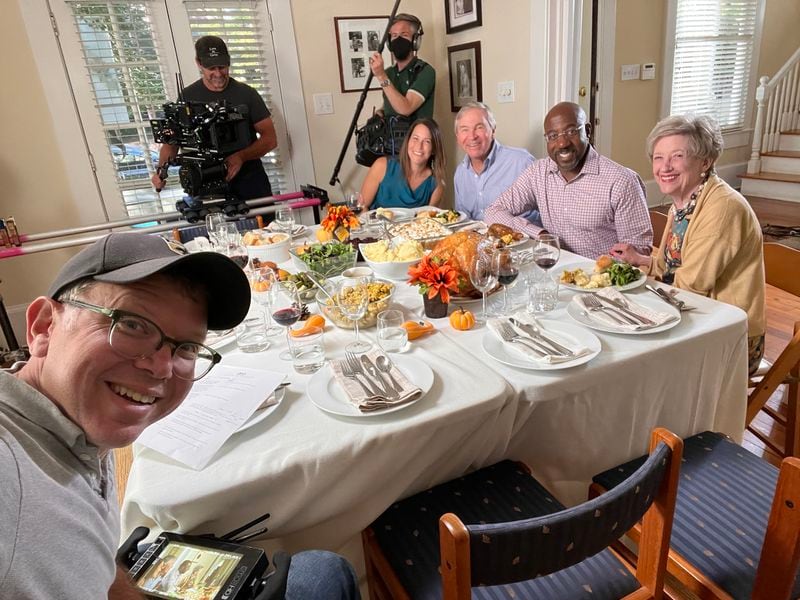 Adam Magus, far left, is shown filming a Thanksgiving ad with U.S. Sen. Raphael Warnock, one of 97 commercials the Warnock campaign aired this election cycle. (Courtesy Adam Magnus)