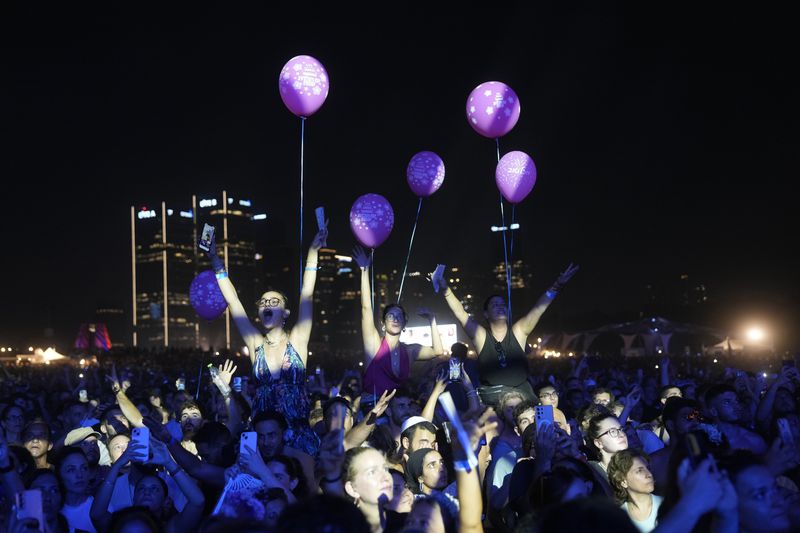 People take part in the Nova Healing Concert in Tel Aviv, Israel, on Thursday, June 27, 2024. This was the first Tribe of Nova mass gathering since the Oct. 7, 2023 cross-border attack by Hamas that left hundreds at the Nova music festival dead or kidnapped to Gaza. (AP Photo/Ohad Zwigenberg)