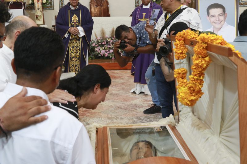 Relatives of slain Mayor Alejandro Arcos cry during his funeral service, one week after he took office, in Chilpancingo, Guerrero state, Mexico, Monday, Oct. 7, 2024. (AP Photo/Alejandrino Gonzalez)