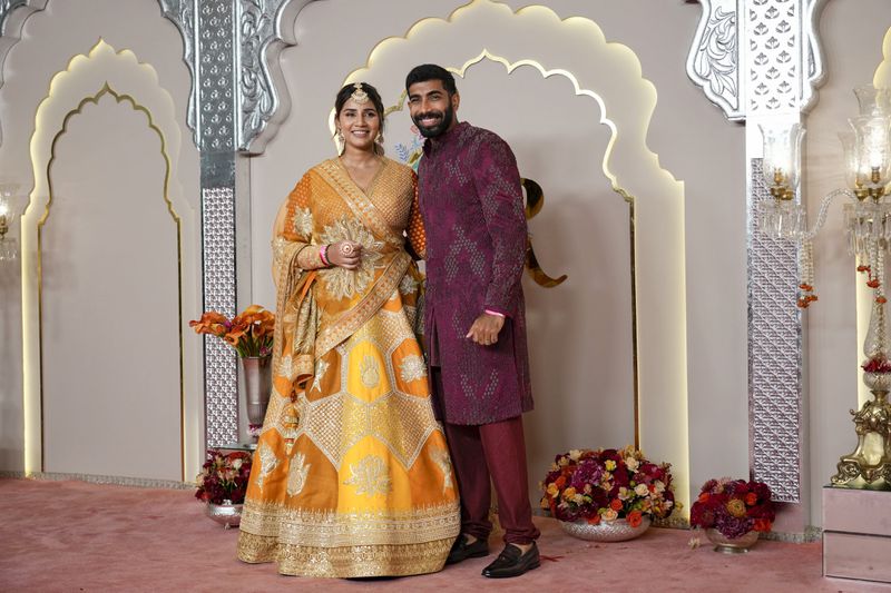 Indian cricketer Jasprit Bumrah poses for a photograph with his wife Sanjana Ganesan at the wedding of Billionaire Mukesh Ambani's son Anant Ambani and Radhika Merchant at Jio World Convention Centre in Mumbai, India, Friday, July 12, 2024. (AP Photo /Rajanish Kakade)