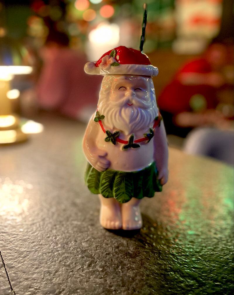 The Subway Speakeasy's Bad Santa, an eggnog, brandy and amaretto mix, is served in a Santa Tiki vessel that is available for purchase. Angela Hansberger for The Atlanta Journal-Constitution