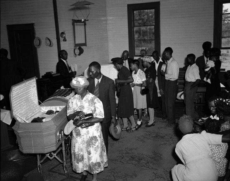 Mourners file past open casket of World War II veteran George Dorsey and his sister Dorothy Malcom at Mount Perry Baptist Church in Bishop, Georgia, on July 28,1946. They were victims of the infamous Moore's Ford Lynching, a quadruple killing that took place in the summer of 1946 on a bridge in Walton and Oconee counties between Monroe and Watkinsville. The case attracted national attention. While the FBI investigated in 1946, it was unable to prosecute.