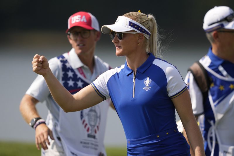 Europe's Charley Hull celebrates after winning a foursome match during a Solheim Cup golf tournament at Robert Trent Jones Golf Club, Saturday, Sept. 14, 2024, in Gainesville, Va. (AP Photo/Matt York)