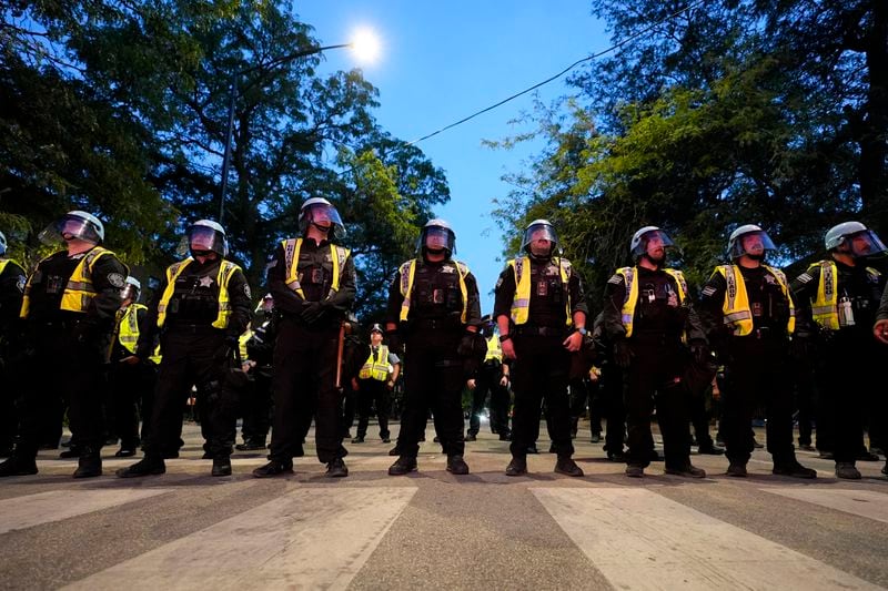 Police watch as protesters march during a demonstration near the Democratic National Convention Thursday, Aug. 22, 2024, in Chicago. (AP Photo/Alex Brandon)