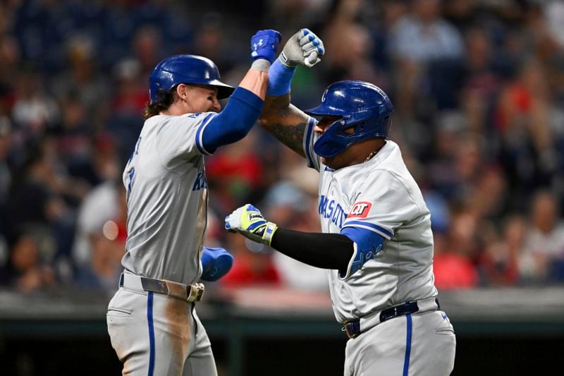 Kansas City Royals' Bobby Witt Jr. and Salvador Perez celebrate after a grand slam hit by Perez during the sixth inning of the second game of a baseball doubleheader against the Cleveland Guardians, Monday, August 26, 2024, in Cleveland. (AP Photo/Nick Cammett)