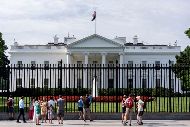 Visitors stand outside the White House, Tuesday, July 23, 2024, in Washington. (AP Photo/Julia Nikhinson)