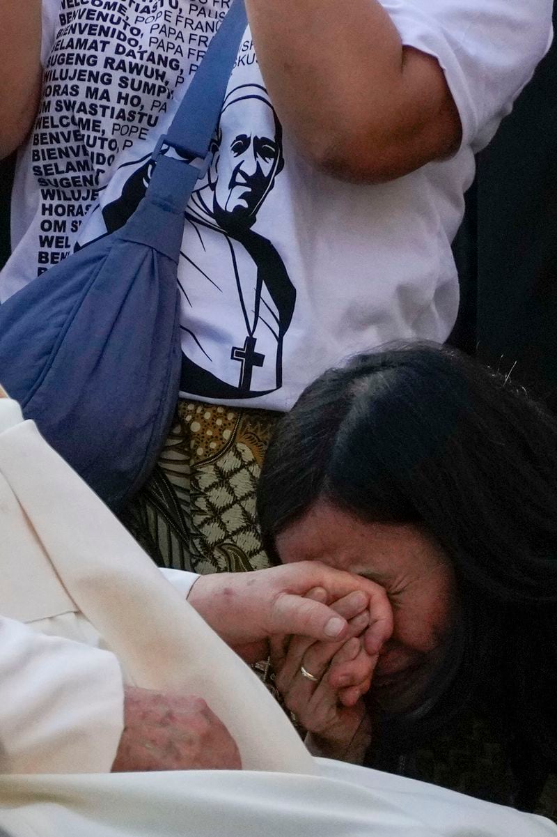 Pope Francis is greeted by faithful as he arrives at the Cathedral of Our Lady of the Assumption in Jakarta, Wednesday, Sept. 4, 2024. Pope Francis urged Indonesia to live up to its promise of "harmony in diversity" and fight religious intolerance on Wednesday, as he set a rigorous pace for an 11-day, four-nation trip through tropical Southeast Asia and Oceania that will test his stamina and health. (AP Photo/Gregorio Borgia)