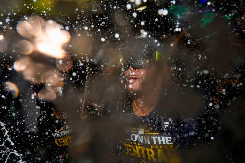 Milwaukee Brewers' Freddy Peralta is douced after a baseball game against the Philadelphia Phillies Wednesday, Sept. 18, 2024, in Milwaukee. The Brewers won 2-1 and clinched the National League Central division. (AP Photo/Morry Gash)