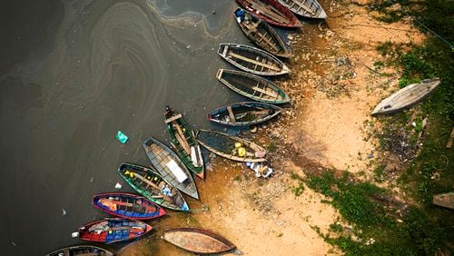 Fishing boats sit on the shore of the Paraguay River in Mariano R. Alonso, Paraguay, Monday, Sept. 9, 2024. Water levels have plunged to their lowest-ever level amid a drought, according to Paraguay's Meteorology and Hydrology Office. (AP Photo/Jorge Saenz)