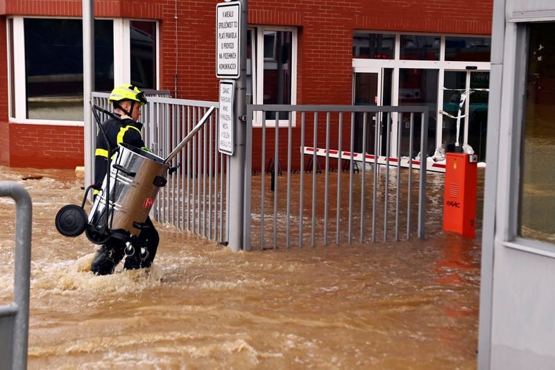 A firefighter wades through flooded streets in Opava, Czech Republic, Sunday Sept. 15, 2024. (Jaroslav Ozana/CTK via AP)