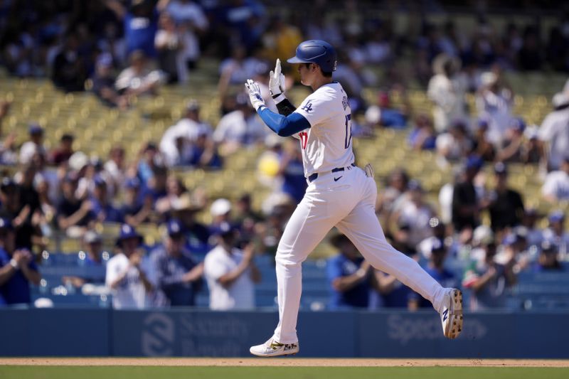 Los Angeles Dodgers' Shohei Ohtani gestures as he heads to third after hitting a solo home run during the fifth inning of a baseball game against the Cleveland Guardians, Sunday, Sept. 8, 2024, in Los Angeles. (AP Photo/Mark J. Terrill)