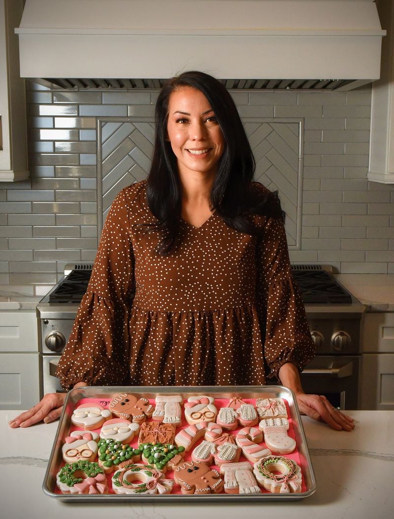 Sam Opdenbosch of Sam’s Cookie Company is shown in her home kitchen in Marietta with some of her original cookie creations. (Styling by Sam Opdenbosch / Chris Hunt for the AJC)