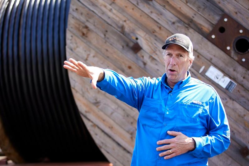 Burke Hales, chief scientist for the PacWave wave energy test site overseen by Oregon State University, stands in front of the electric cables that are buried under the seabed in Newport, Ore., Friday, Aug. 23, 2024. (AP Photo/Craig Mitchelldyer)