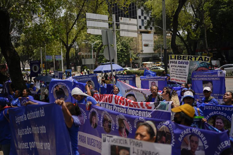 Relatives of prisoners rally in favor of the government's proposed judicial reform in Mexico City, Wednesday, Sept. 4, 2024. (AP Photo/Felix Marquez)