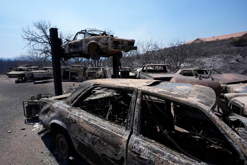 Charred vehicles are left behind after the Airport Fire swept through Thursday, Sept. 12, 2024, in El Cariso Village, in unincorporated Riverside County, Calif. (AP Photo/Gregory Bull)