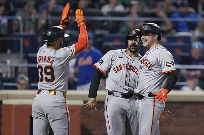 San Francisco Giants' Patrick Bailey, right, celebrates with LaMonte Wade Jr., center, and Thairo Estrada after hitting a grand slam against the New York Mets during the eighth inning of a baseball game Friday, May 24, 2024, in New York. (AP Photo/Frank Franklin II)