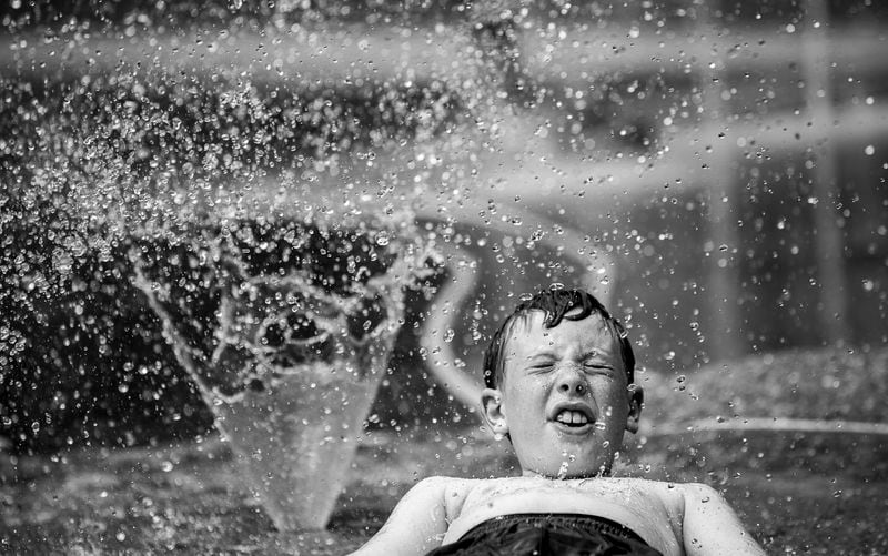 9-year-old Wyatt Flagherty cooled off as temperatures rose in Louisville, Ky., at the Iroquois Park sprayground on Tuesday, June 18, 2024. (Jeff Faughender/Courier Journal/USA Today Network via AP)