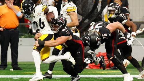 Pittsburgh Steelers cornerback Donte Jackson (26) is tackled by Atlanta Falcons center Drew Dalman (67) after an interception during the second half of an NFL football game Sunday, Sept. 8, 2024, in Atlanta. (AP Photo/Butch Dill)