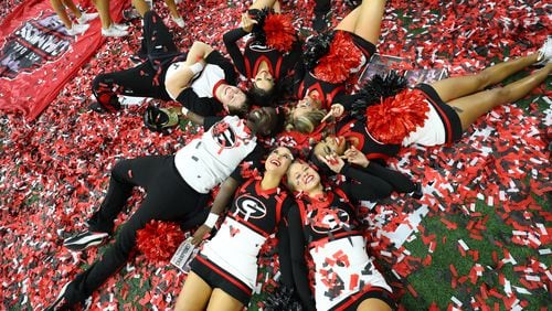 1/10/22 - Indianapolis - Georgia Bulldog cheerleaders celebrate in the confetti on the field following their 33-18 win against the Alabama Crimson Tide at the 2022 College Football Playoff National Championship at Lucas Oil Stadium in Indianapolis on Monday, January 10, 2022.  Curtis Compton / Curtis.Compton@ajc.com 