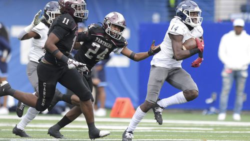 Cedar Grove wide receiver Barry Jackson (14) avoids a tackle by Carver-Atlanta corner back Kani Smith (24) and carries the ball for a first down in the first half of a GHSA class AAA championship game Saturday, Dec. 11, 2021 at Center Parc Stadium in Atlanta. (Daniel Varnado/ For the Atlanta Journal-Constitution)