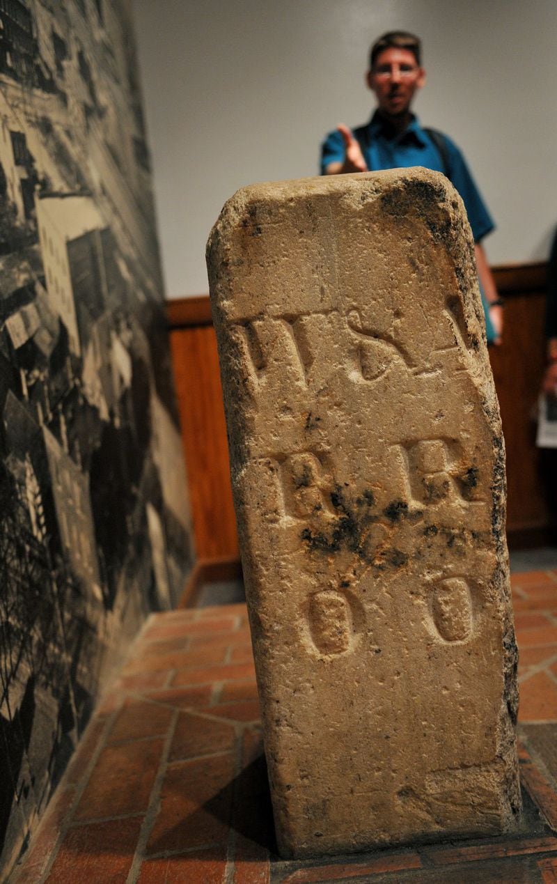 Jeff Morrison, an architect who runs walking tours of Atlanta’s historic sites downtown, shows the Zero Mile Post during a tour in 2008. The inscription on the post, in place since 1850, reads “W&A / RR / 00” in reference to the Western & Atlanic Railroad, which was commissioned by the Georgia Legislature in 1836. The post marks the terminus of the W&A line, from which a settlement grew and eventually became Atlanta. (Rich Addicks / AJC archive)