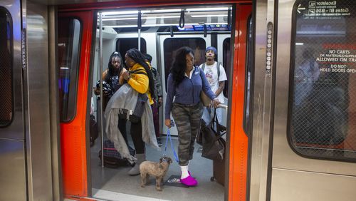 Travelers ride on the plane train on Friday, December 9, 2022, at Hartsfield Jackson International airport in Atlanta. Several retail and concession spaces are up for lease at the airport. CHRISTINA MATACOTTA FOR THE ATLANTA JOURNAL-CONSTITUTION.