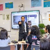 Rashad Brown teaches Advanced Placement African American Studies at Maynard Jackson High School on Friday, Feb. 17, 2023.  Students participate in dialogue and debate, present projects and consider why restrictions are being put on the course in other states.  (Jenni Girtman for The Atlanta Journal-Constitution)